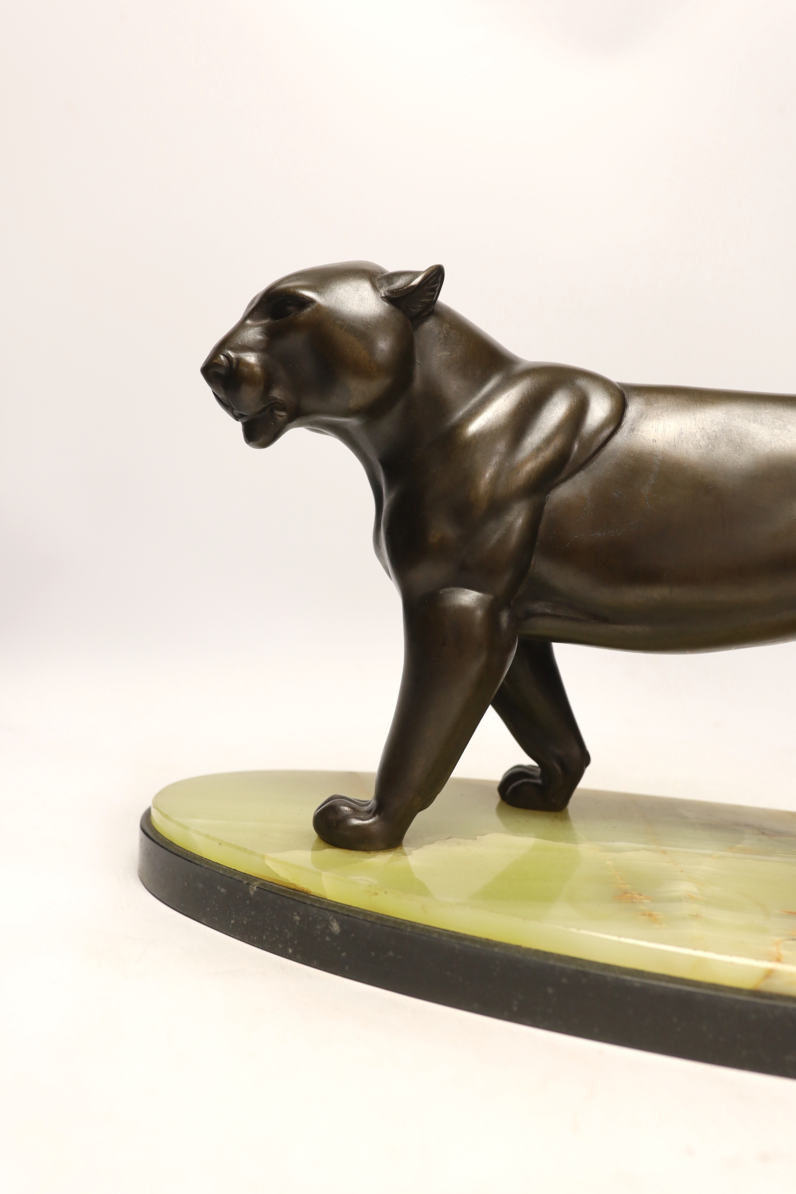 An Art Deco bronzed spelter figure of a panther, attributed to Rochard, on marble base, 56cm long